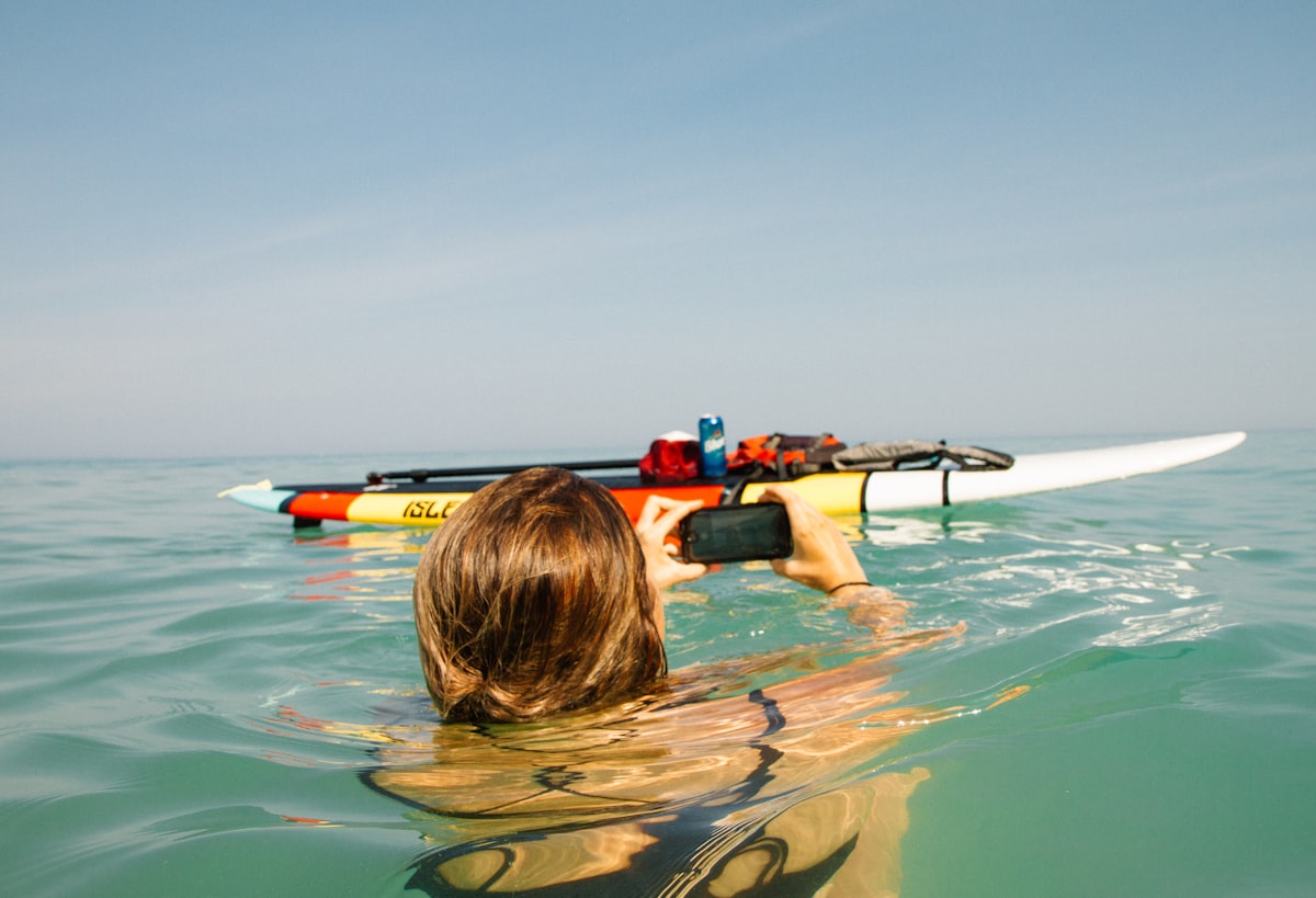 An underwater view of a surfer diving beneath the ocean surface
