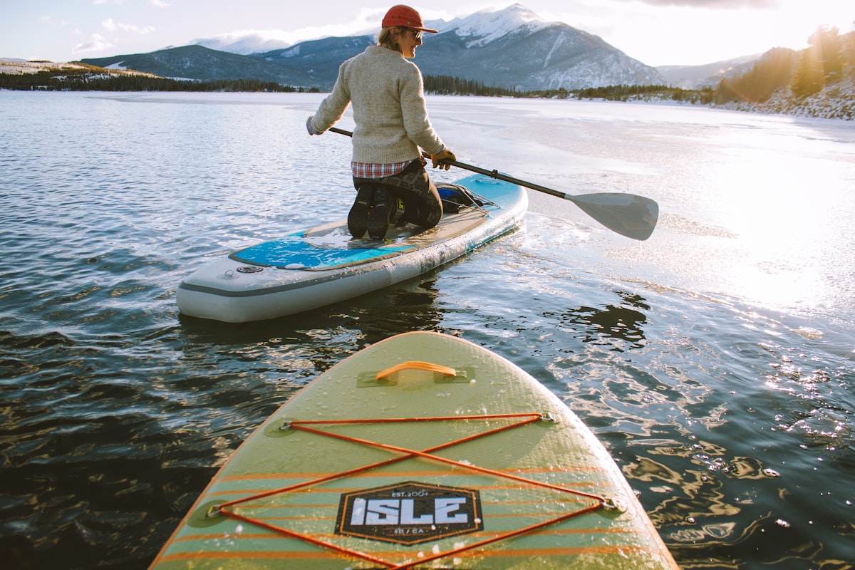 A surfer paddling toward an incoming wave at the peak