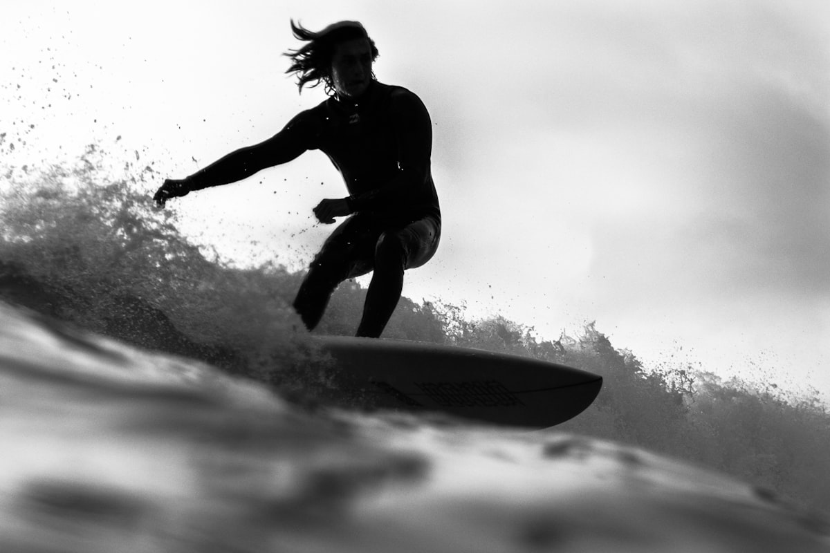 A surfer generating speed on the open face of a wave