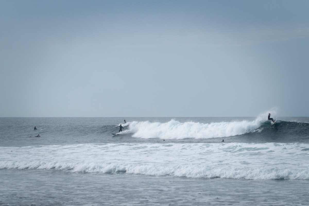 A surfer carving a hard bottom turn on a perfectly shaped wave